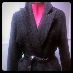 Long wool coat with leather tie at waste.